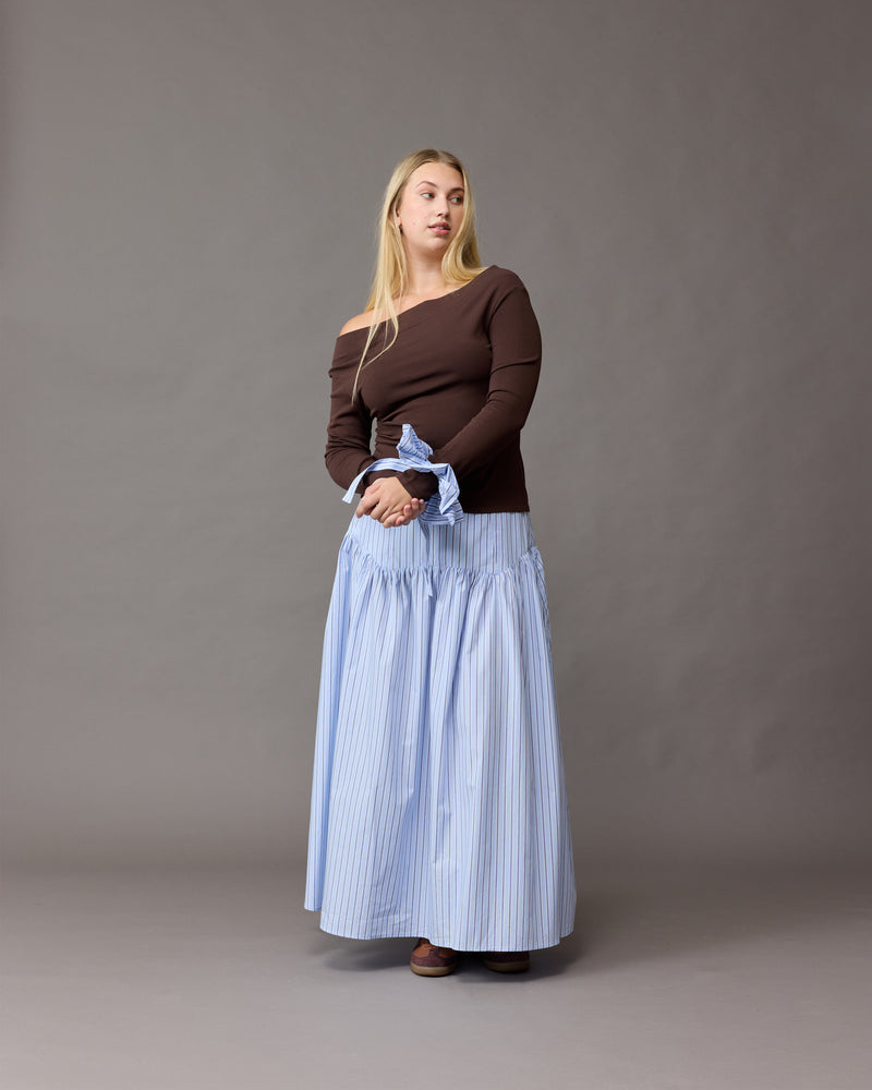 TRULLI SKIRT BLUE SKY STRIPE | Floaty basque style maxi skirt imagined in a blue stripe cotton. This skirt features a dropped bodice style waistline, that falls to a full, wide skirt.