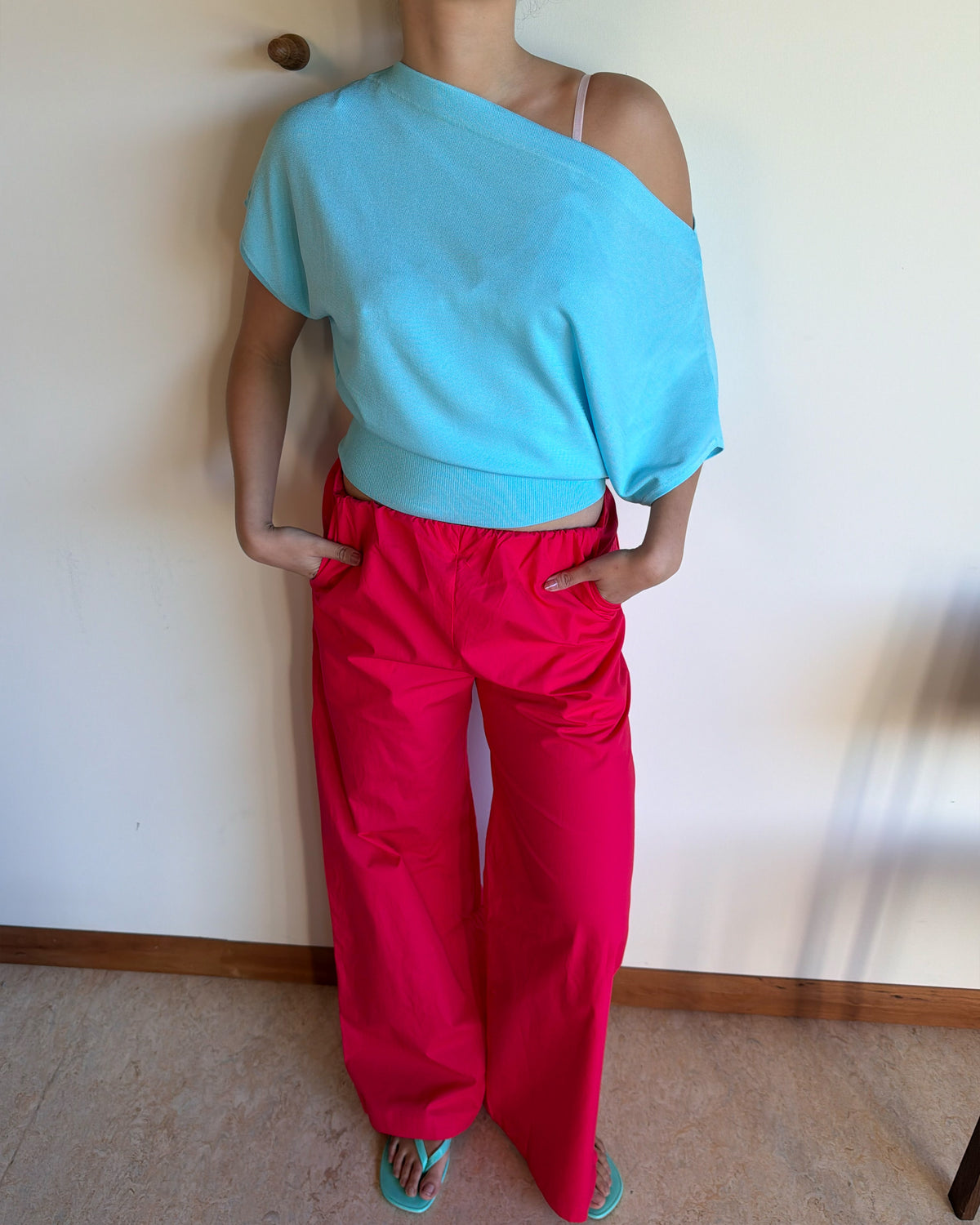 BODE BATWING SHORT SLEEVE TOP AQUA | Off-shoulder batwing short sleeve top crafted in a mid-weight aqua knit. This top is simple yet elevated and can be worn on or off the shoulder. Pair it with denim for a chic everyday look.