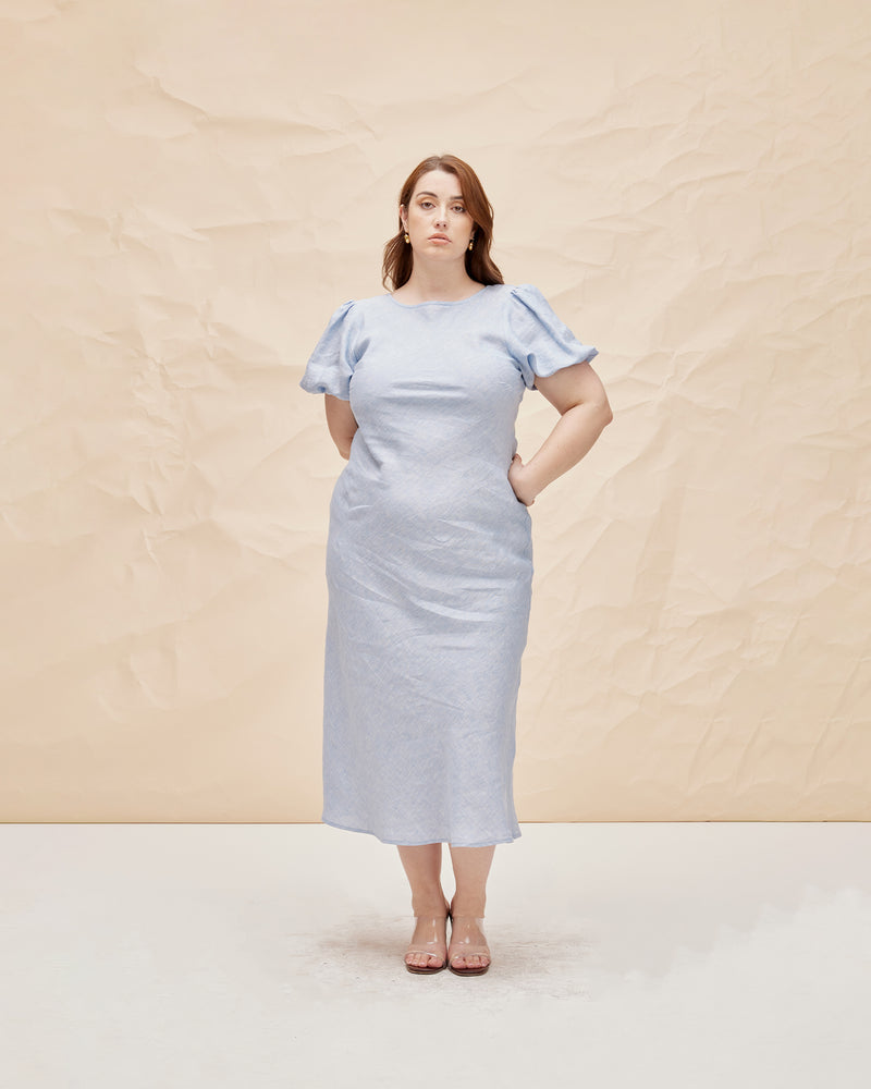 KOS LINEN DRESS BABY BLUE | An update on a much loved Rubette favourite, the Kos Linen Dress is a bias cut dress with a subtle puff sleeve and cut out back with neck-ties. Cut from...