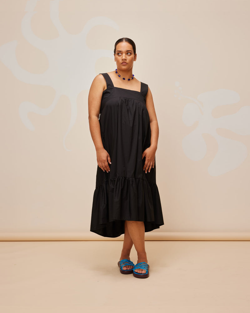 MARGIE TIE-BACK DRESS BLACK | Cotton maxi dress with a square band neckline. The skirt falls in soft tiers with an exposed back and bow tie closure.