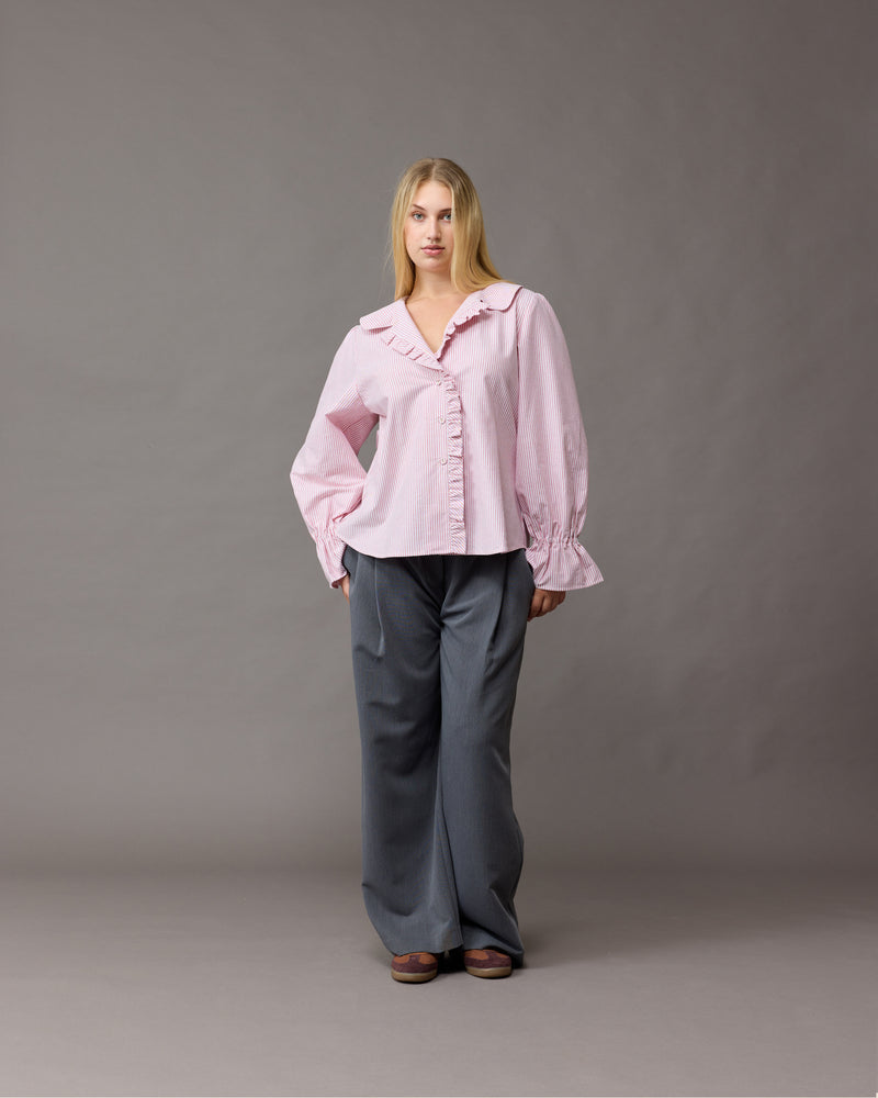 SANDLER RUFFLE SHIRT RED STRIPE | Longsleeve pink striped shirt with ruffles down the placket and a rounded collar. This top features elasticated ruffle cuffs, this piece is an elevated take on the classic shirt shape.