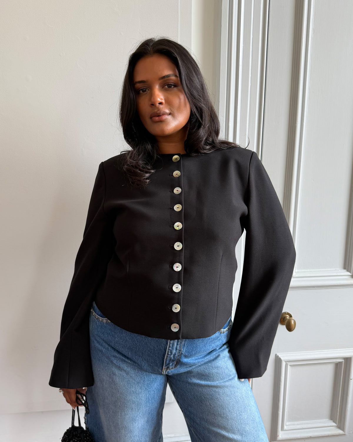 CAROLYN BLAZER BLACK | Collarless long sleeve black blazer with feature pearlescent buttons.  An elevated classic with a structured silhouette, this top is the perfect addition to your everyday workwear rotation. Pair with your favourite trousers, or denim for a more casual look.   RUBY...