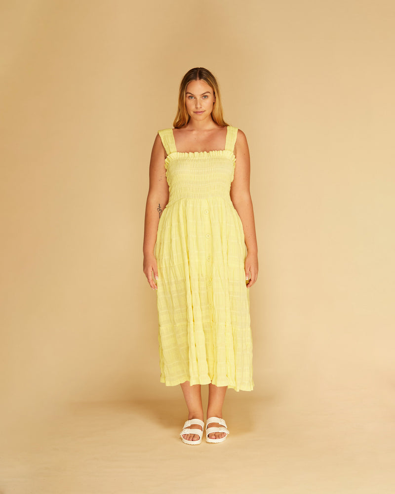 MIRELLA BUTTON-DOWN SUNDRESS LEMON | Midi length dress shirred at the bodice for a close fit, this piece gently flares out through the button down tiered skirt. Crafted in signature RUBY Mirella fabric, in a...