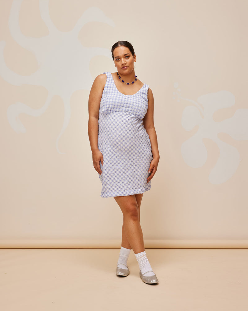 PRISM MINIDRESS PERIWINKLE GINGHAM | Sleeveless mini dress with a round scooped neckline, designed in a seersucker textured. The periwinkle shade of this piece add to its playful vibe.