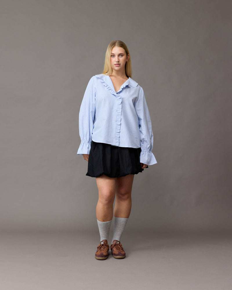 SANDLER RUFFLE SHIRT BLUE STRIPE | Longsleeve blue striped shirt with ruffles down the placket and a rounded collar. This top features elasticated ruffle cuffs, this piece is an elevated take on the classic shirt shape.