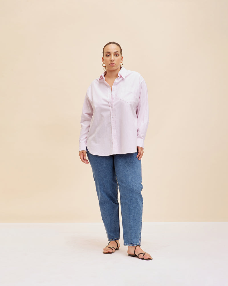 ALLORA SHIRT PINK STRIPE | Oversized crisp shirt with classic shirt detailing and a large front pocket, designed in a pink striped cotton. This piece is a timeless wardrobe staple that you will wear for...