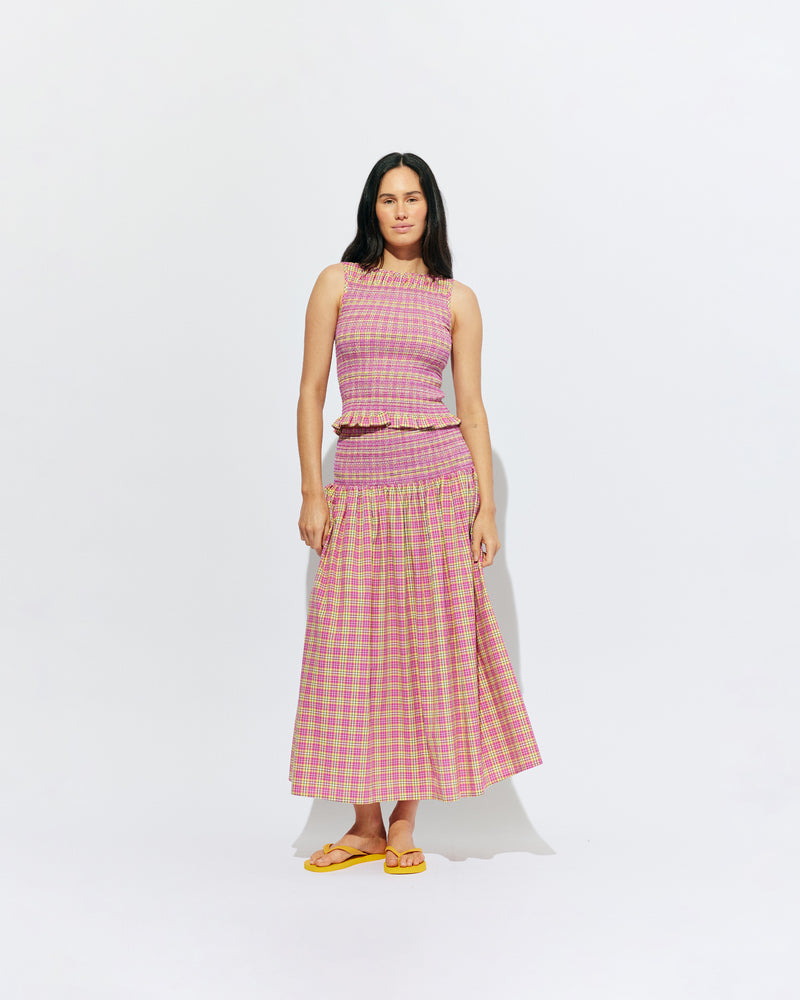 ANASTASIA SKIRT PINK YELLOW TARTAN | Cotton maxi skirt designed in a pink yellow tartan and crafted in 100% organic cotton, with a shirred waist and hip that falls to a floaty, full skirt. This skirt can be worn as a pop of colour paired with...