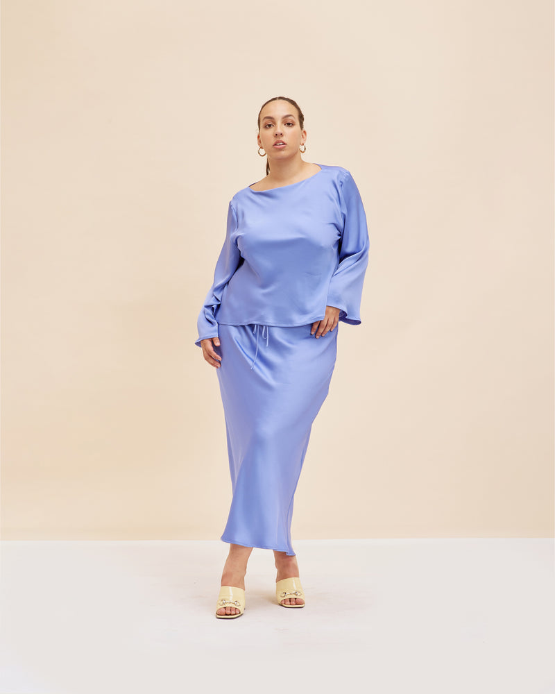ANDIE SATIN SKIRT PERIWINKLE | Bias cut straight skirt designed in a luxe periwinkle satin. Features a drawstring at the waist to let you decide how high or low you want to wear it. This...
