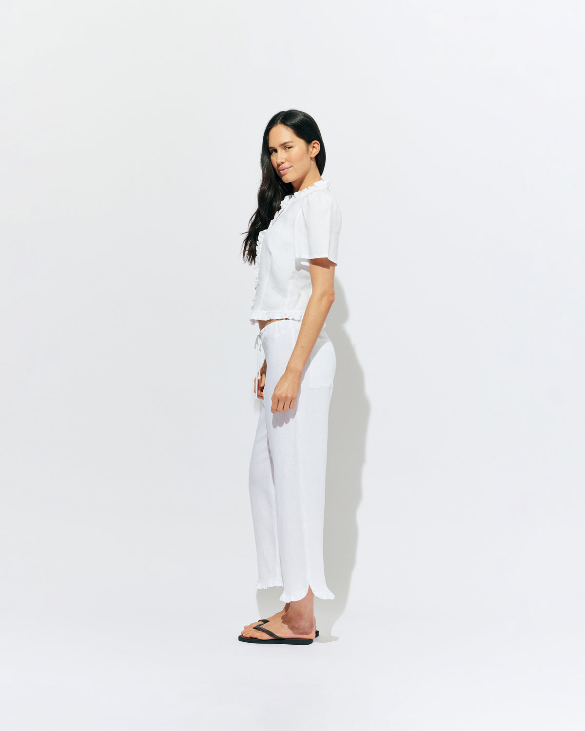 ARLO LINEN TOP WHITE | White linen button up blouse with ruffle detailing around the neckline, hem and down the front. A great addition to your workwear wardrobe, pair with denim for a sweet and simple look. 