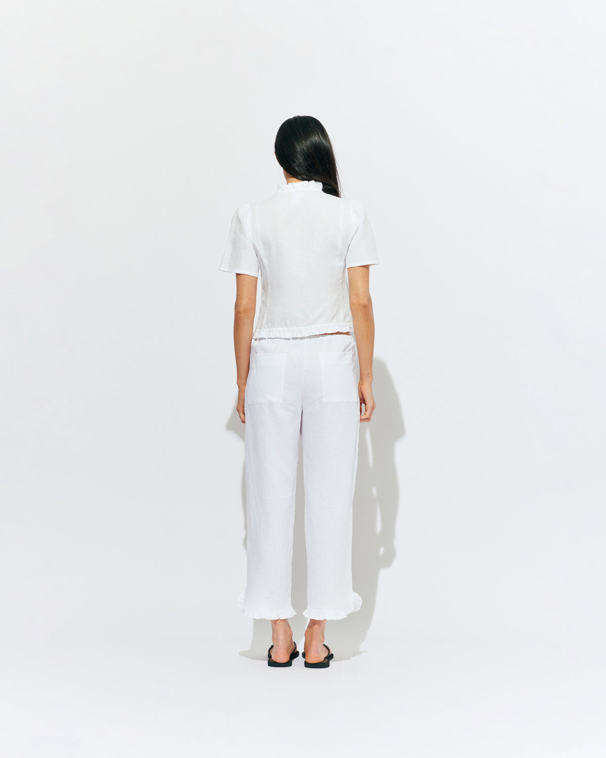 ARLO LINEN TOP WHITE | White linen button up blouse with ruffle detailing around the neckline, hem and down the front. A great addition to your workwear wardrobe, pair with denim for a sweet and simple look. 