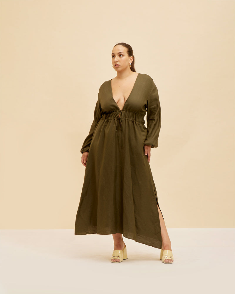 AVALON LINEN MAXI DRESS KHAKI | Loose fit linen maxi dress with long blouson sleeves and a V-neckline. Features a double drawstring at the waist that falls to an A-line skirt and pockets to house all...