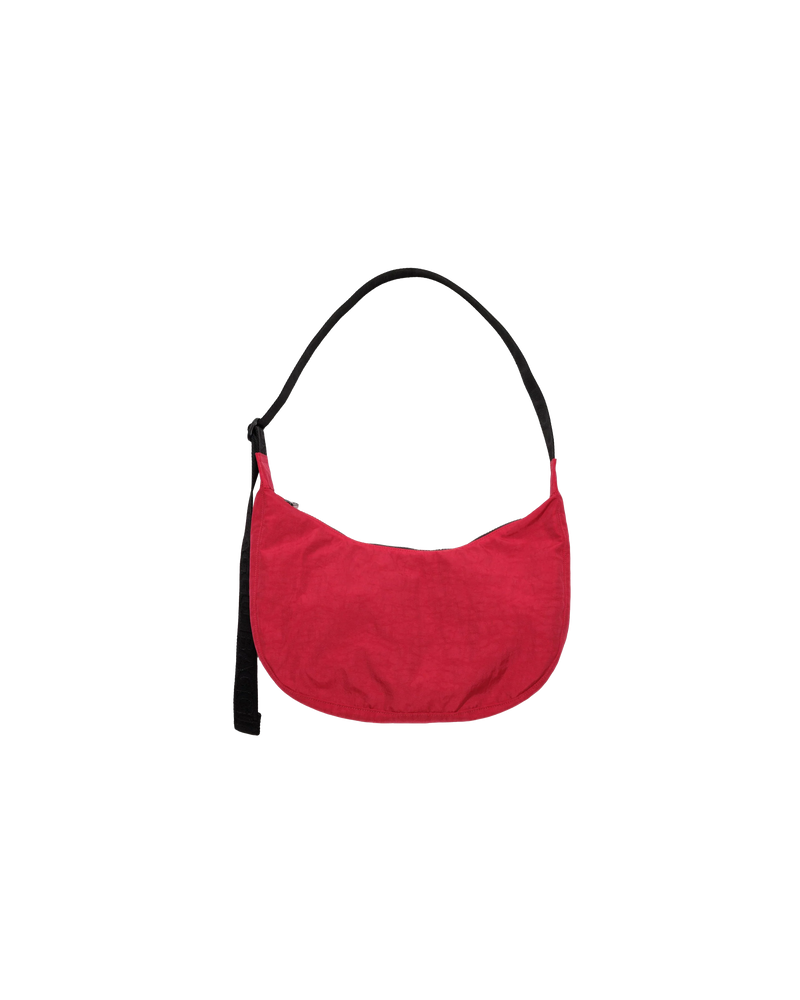 MEDIUM NYLON CRESCENT BAG CANDY APPLE | Crescent shaped nylon bag with a feature 'BAGGU' strap. An adjustable strap gives you multiple ways and lengths to wear this bag.