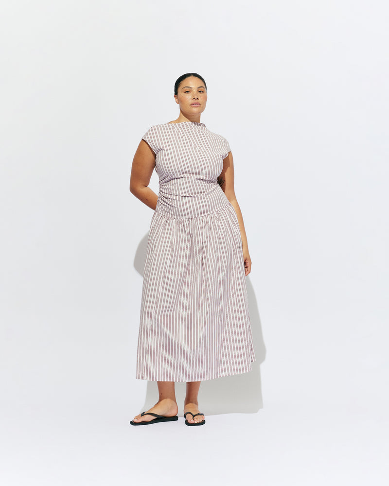 BIRDIE MAXI DRESS PINK LADY STRIPE | Drop waist maxi dress designed in our organic cotton pink lady stripe. Featuring a high neck collar, pleated skirt and a gather detail on the lower back designed for better fit and movement. Layer with one of our Blazers for...