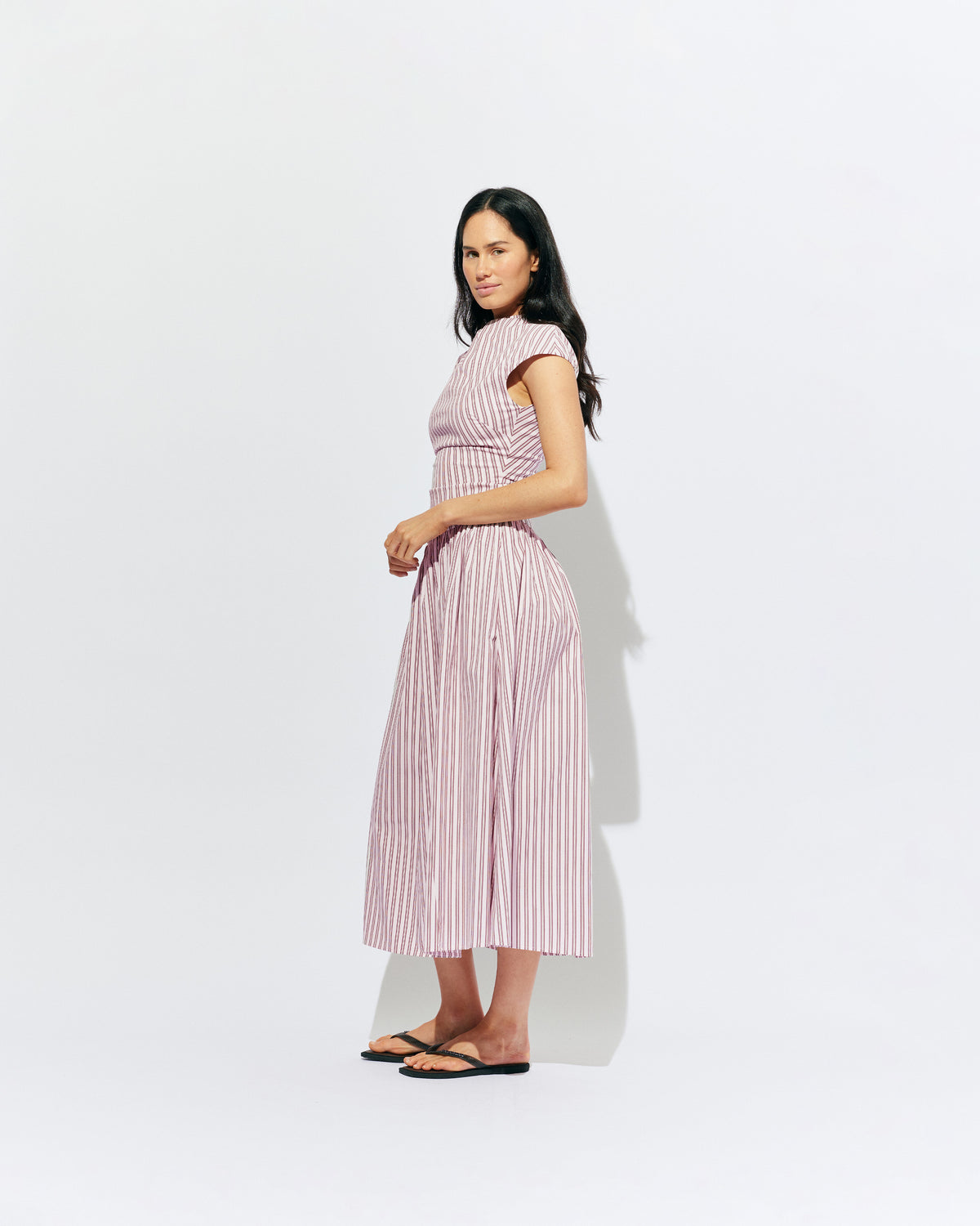 BIRDIE MAXI DRESS PINK LADY STRIPE | Drop waist maxi dress designed in our organic cotton pink lady stripe. Featuring a high neck collar, pleated skirt and a gather detail on the lower back designed for better fit and movement. Layer with one of our Blazers for...