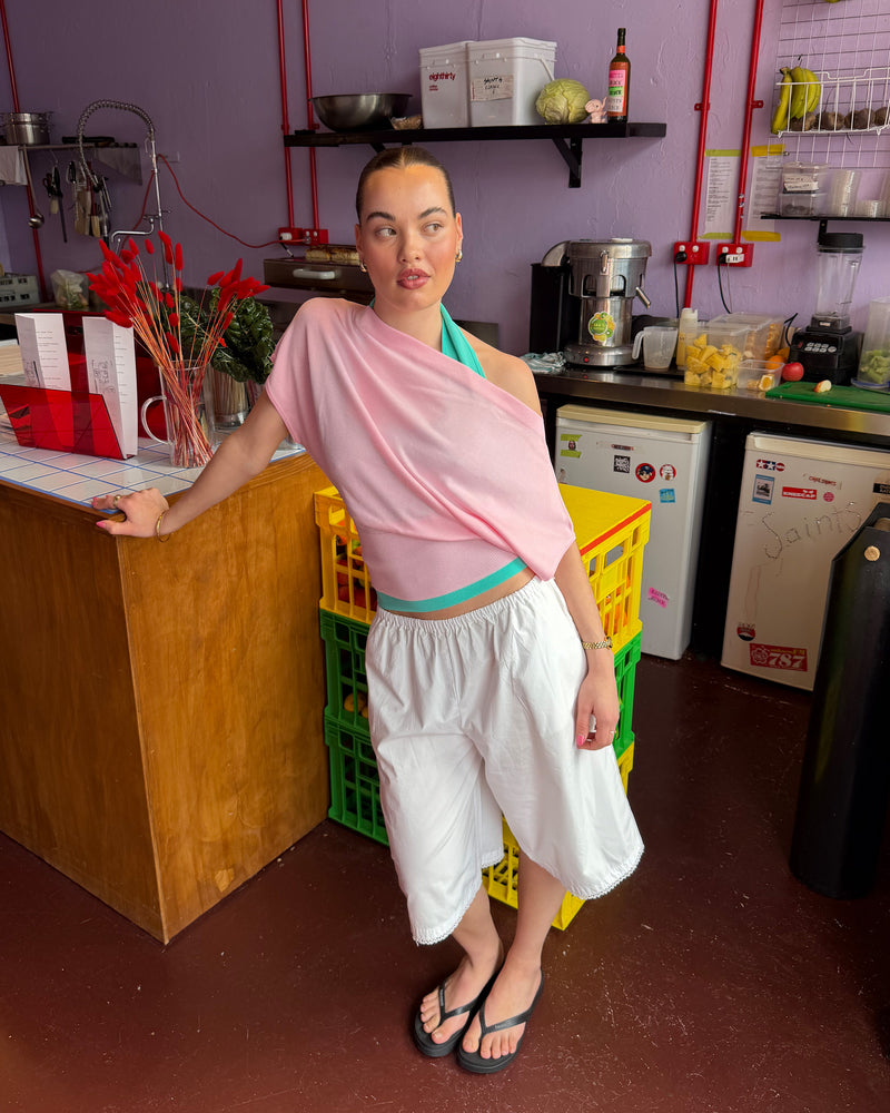 BODE BATWING SHORT SLEEVE TOP PINK | Off-shoulder batwing short sleeve top crafted in a mid-weight pink knit. This top is simple yet elevated and can be worn on or off the shoulder. Pair it with denim for a chic everyday look.