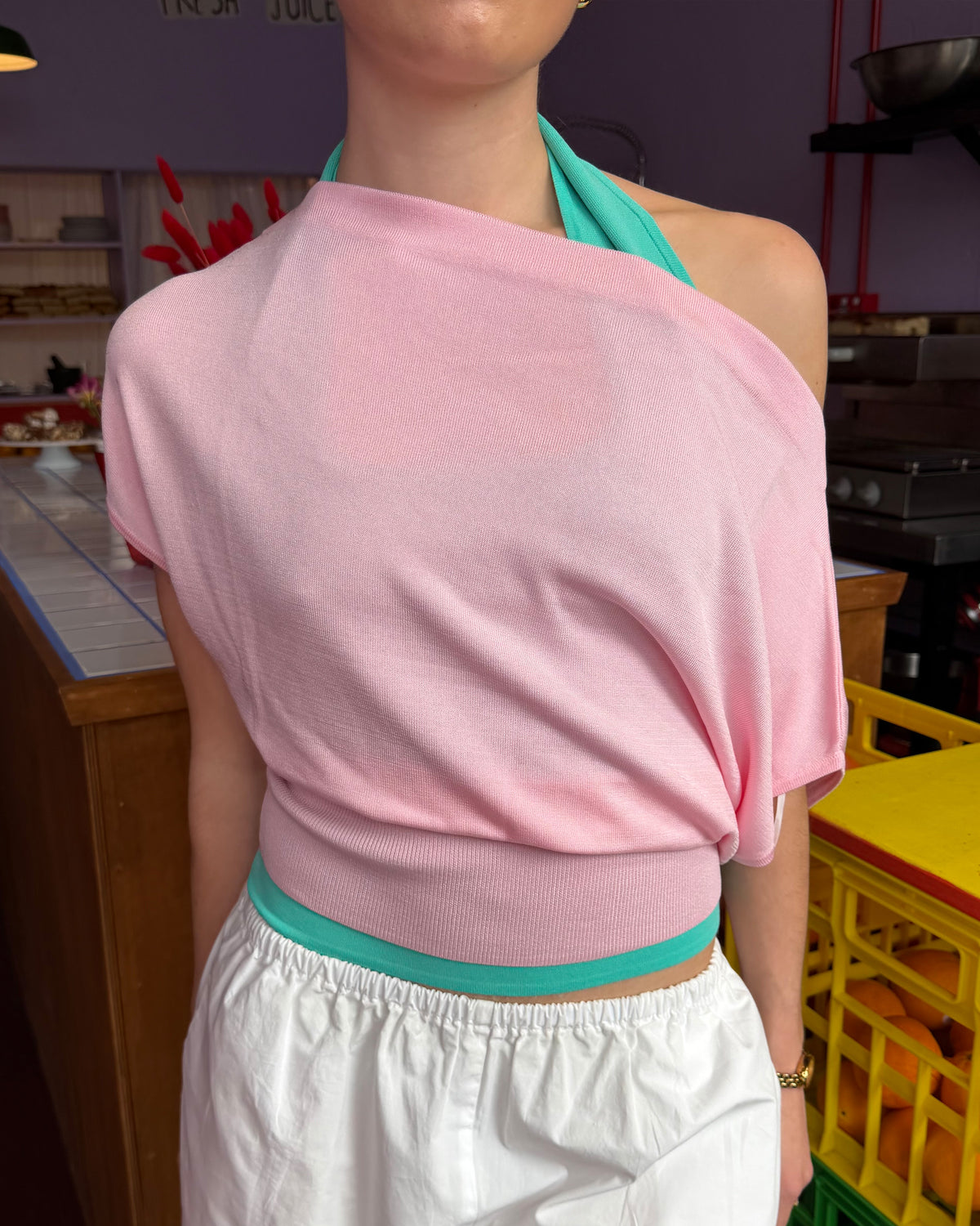 BODE BATWING SHORT SLEEVE TOP PINK | Off-shoulder batwing short sleeve top crafted in a mid-weight pink knit. This top is simple yet elevated and can be worn on or off the shoulder. Pair it with denim for a chic everyday look.