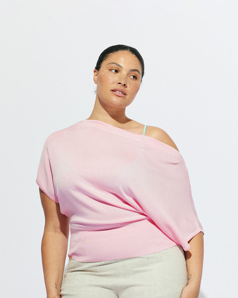 BODE BATWING SHORT SLEEVE TOP PINK | Off-shoulder batwing short sleeve top crafted in a mid-weight pink knit. This top is simple yet elevated and can be worn on or off the shoulder. Pair it with denim for a chic everyday look.