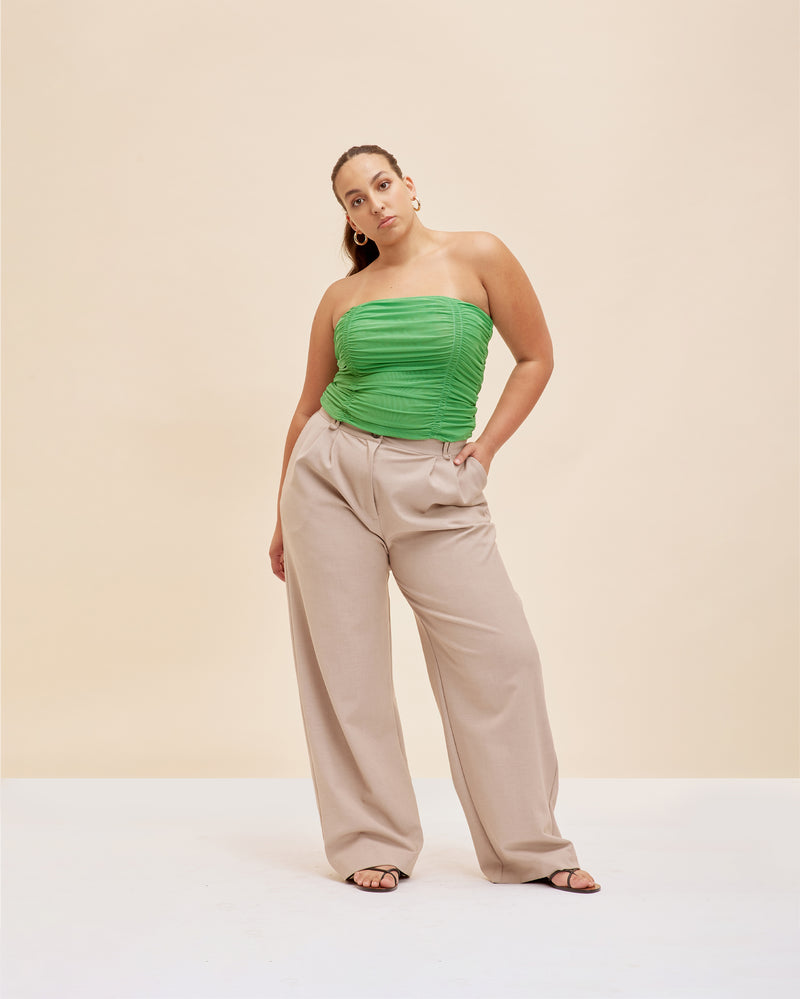 BOUNCE MESH TUBE TOP GREEN | Strapless mesh tube top with ruching down the middle, designed in a bold green shade. Worn on its own or as a layering piece, this elevated basic is timeless.