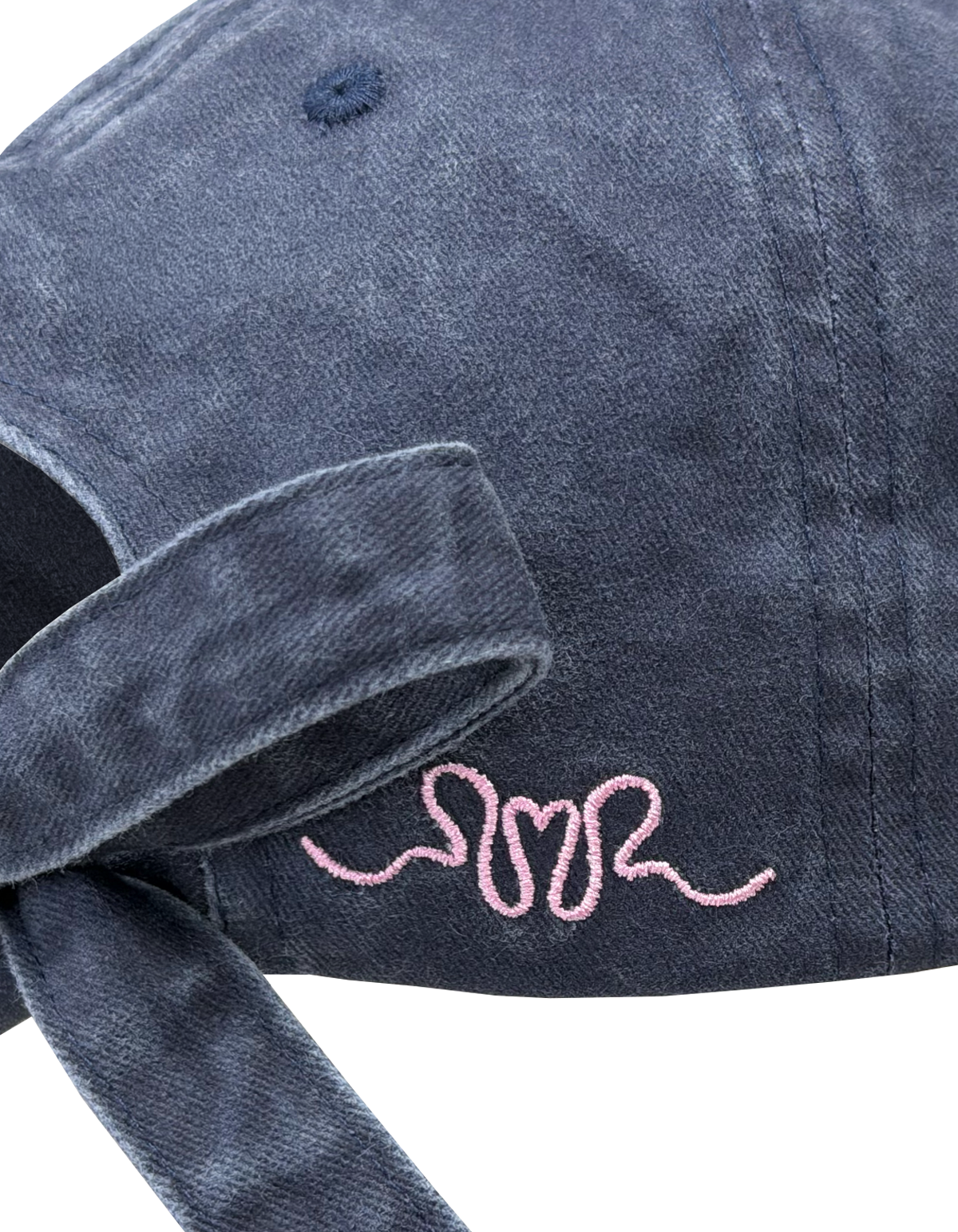 BOW CAP INDIGO | The perfect finishing touch to any outfit, introducing our new Bow Cap in indigo. A RUBY twist on your standard cap, with an adjustable tie featured at the back and our femme logo embroidered in pink on the side.