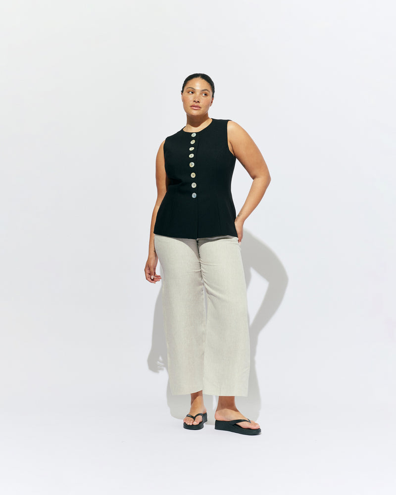 CAROLYN VEST BLACK | The Carolyn Vest is perfect for warmer months and layering, designed in a mid-weight black suiting fabric. With tailored shaping on the waist and a built-in waist tie, pair with your favourite shorts or our Carolyn Pant for an effortlessly...