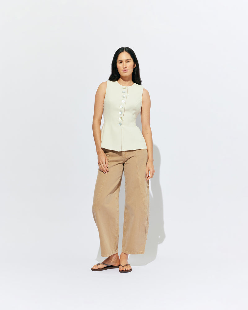 CAROLYN VEST CREAM | The Carolyn Vest is perfect for warmer months and layering, designed in a mid-weight cream textured suiting fabric. With tailored shaping on the waist and a built-in waist tie, pair with your favourite shorts or suit trouser for an effortlessly...