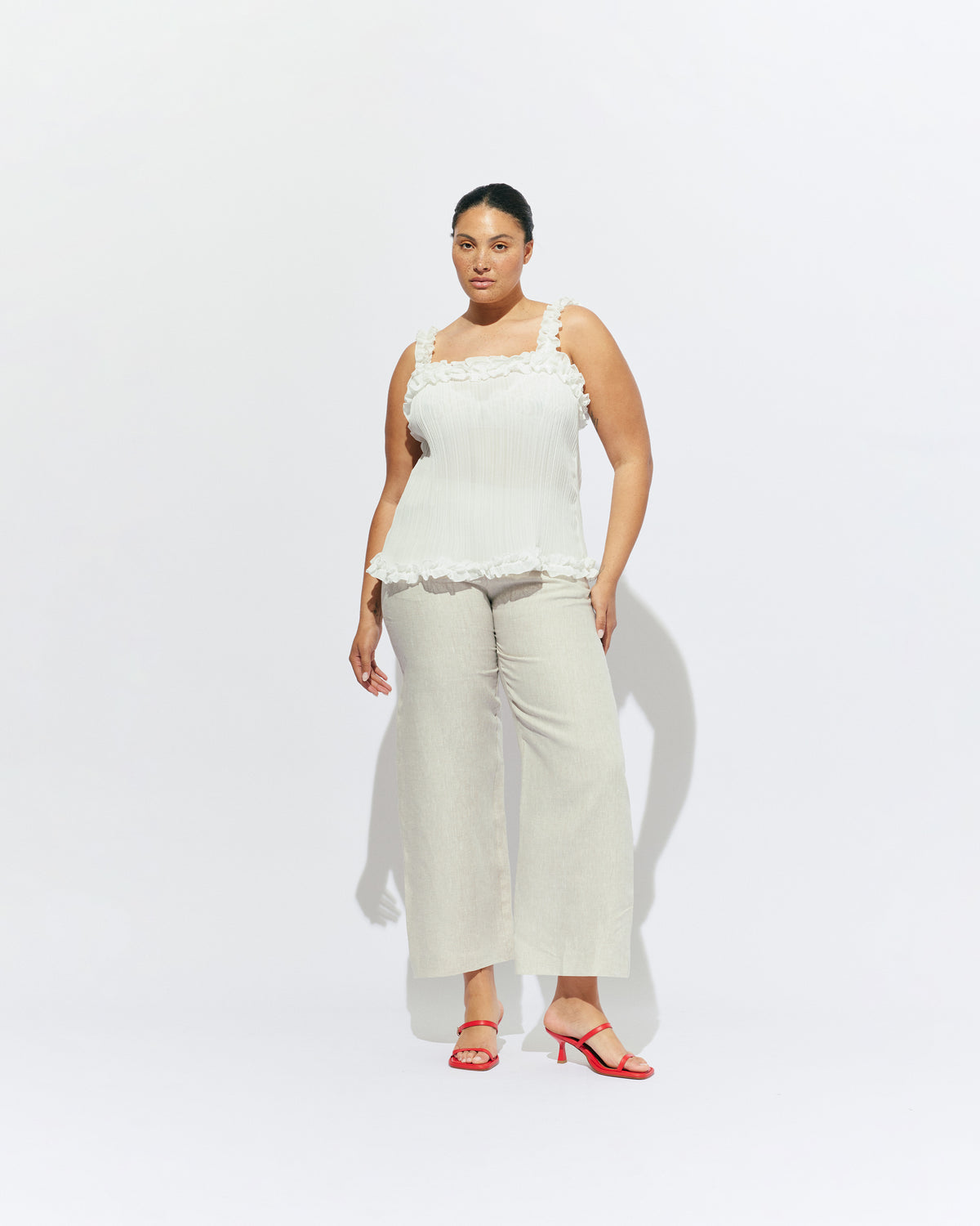CHELSEA CRINKLE CAMI WHITE | A new arrival to our Chelsea Crinkle story, this white recycled chiffon cami features ruffles along all the seams. This top is the perfect statement piece for any occasion: layered with a singlet for the office, or showing off your...