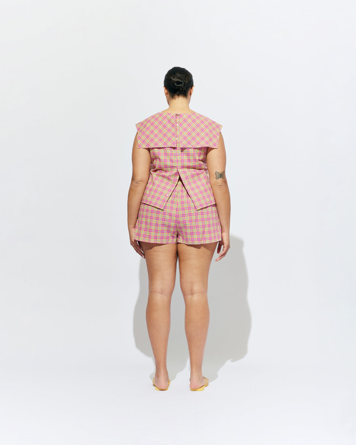 CRUSH BLOUSE PINK YELLOW TARTAN | Sleeveless blouse featuring an oversized sailor-style collar with a scalloped hem and broderie detailing on the sides, designed in our organic cotton pink yellow tartan. Features a button up design at the back, which can be worn open to keep...