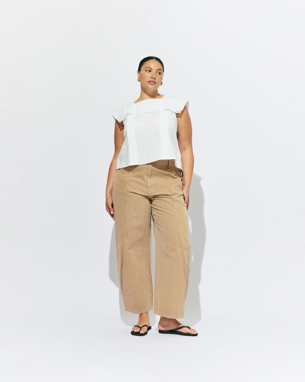 CRUSH BLOUSE WHITE | Sleeveless blouse featuring an oversized sailor-style collar with a scalloped hem and broderie detailing on the sides, designed in our classic white organic cotton. Features a button up design at the back, which can be worn open to keep you...