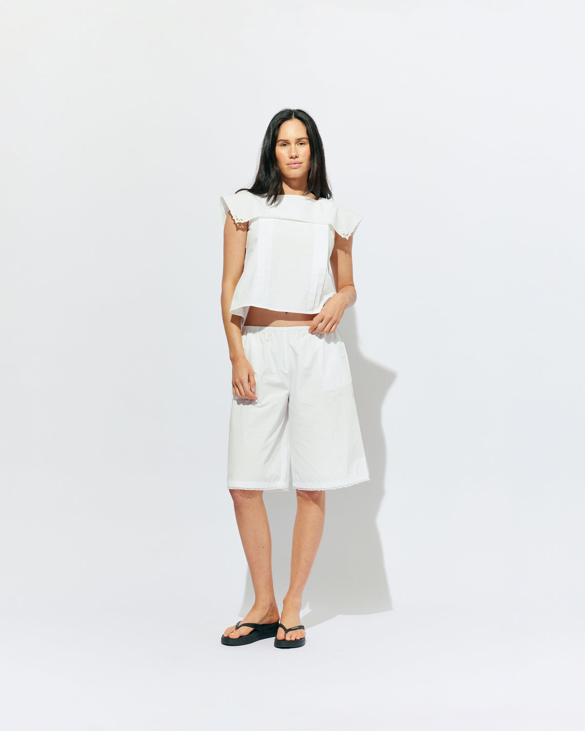 CRUSH BLOUSE WHITE | Sleeveless blouse featuring an oversized sailor-style collar with a scalloped hem and broderie detailing on the sides, designed in our classic white organic cotton. Features a button up design at the back, which can be worn open to keep you...