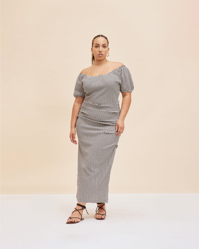 DELPHI GINGHAM DRESS BLACK GINGHAM | Textured gingham midi dress with a subtle side split and elasticated neckline and sleeves. The tucks down the side seam create pleats across the body while the sleeves give you the...