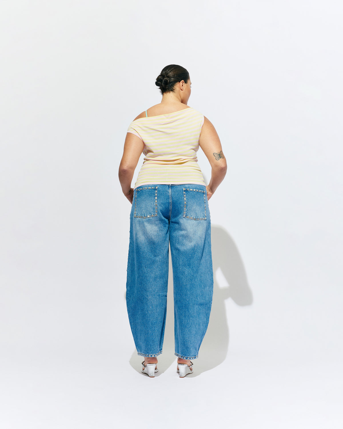 ICON STUDDED JEAN MIDTOWN BLUE | Barrel-leg jean designed in our signature midtown blue wash denim with studded seams. Sits mid to high-waisted with classic 5 pocket and waistband detailing. An updated version of our Icon Jean.