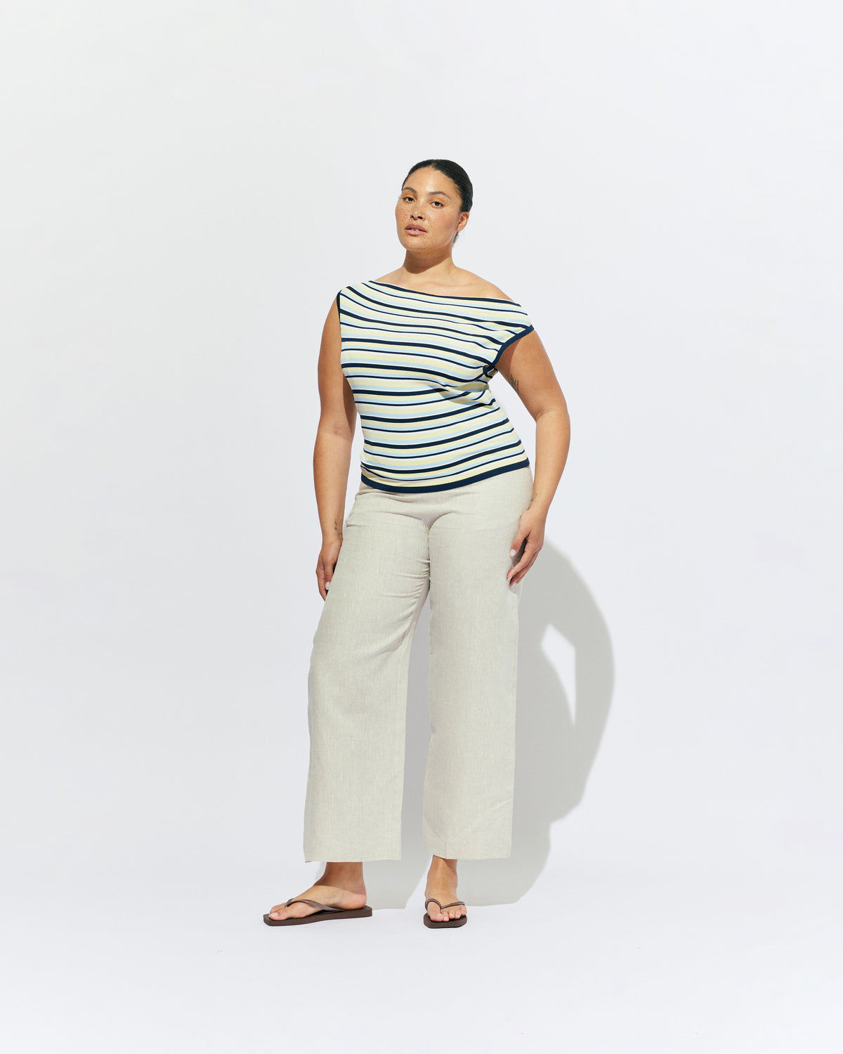 EMMA KNIT TOP LEMON NAVY STRIPE | Off-shoulder knitted top crafted in a lemon navy stripe, mid-weight knit. This top is simple yet fun and can be worn on or off the shoulder.