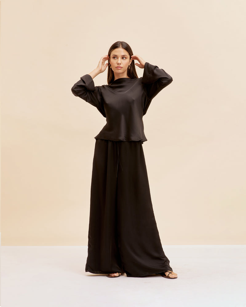 ANDIE SATIN PANT BLACK | Palazzo style pants with an elastic waist band & tie, in a luxurious black satin. These pants are high waisted, uncomplicated and classically cool.
