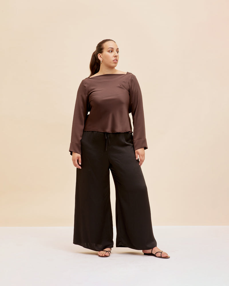  FIREBIRD SATIN COWL TOP ESPRESSO | Longsleeve blouse with a cowl neck scoop back, crafted in sleek espresso coloured satin. A minimal silhouette with an unexpected detail in the draped back neck and a tie to...