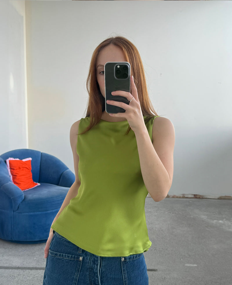 FIREBIRD COWL SLEEVELESS TOP PEA GREEN | Sleeveless top crafted in a luxe pea green satin. Features a minimal silhouette with a cowl back detail and a tie to cinch in the waist. Find out more about...