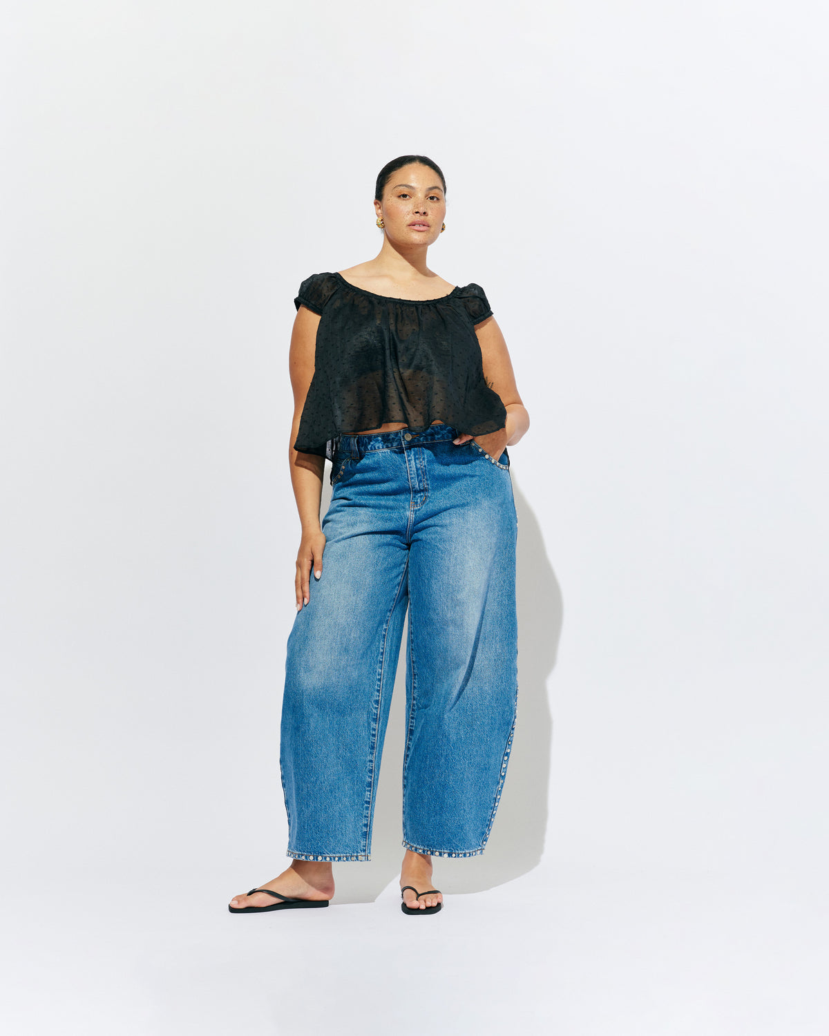 ICON STUDDED JEAN MIDTOWN BLUE | Barrel-leg jean designed in our signature midtown blue wash denim with studded seams. Sits mid to high-waisted with classic 5 pocket and waistband detailing. An updated version of our Icon Jean.