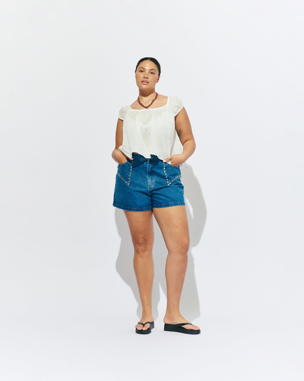 FRECKLE BLOUSE WHITE | Puff sleeve blouse, created in a lightweight semi-sheer ramie fabric, with a textured polka dot design. With a wide neckline that can be worn on or off the shoulder, and a flowy silhouette through the body, this top is the...
