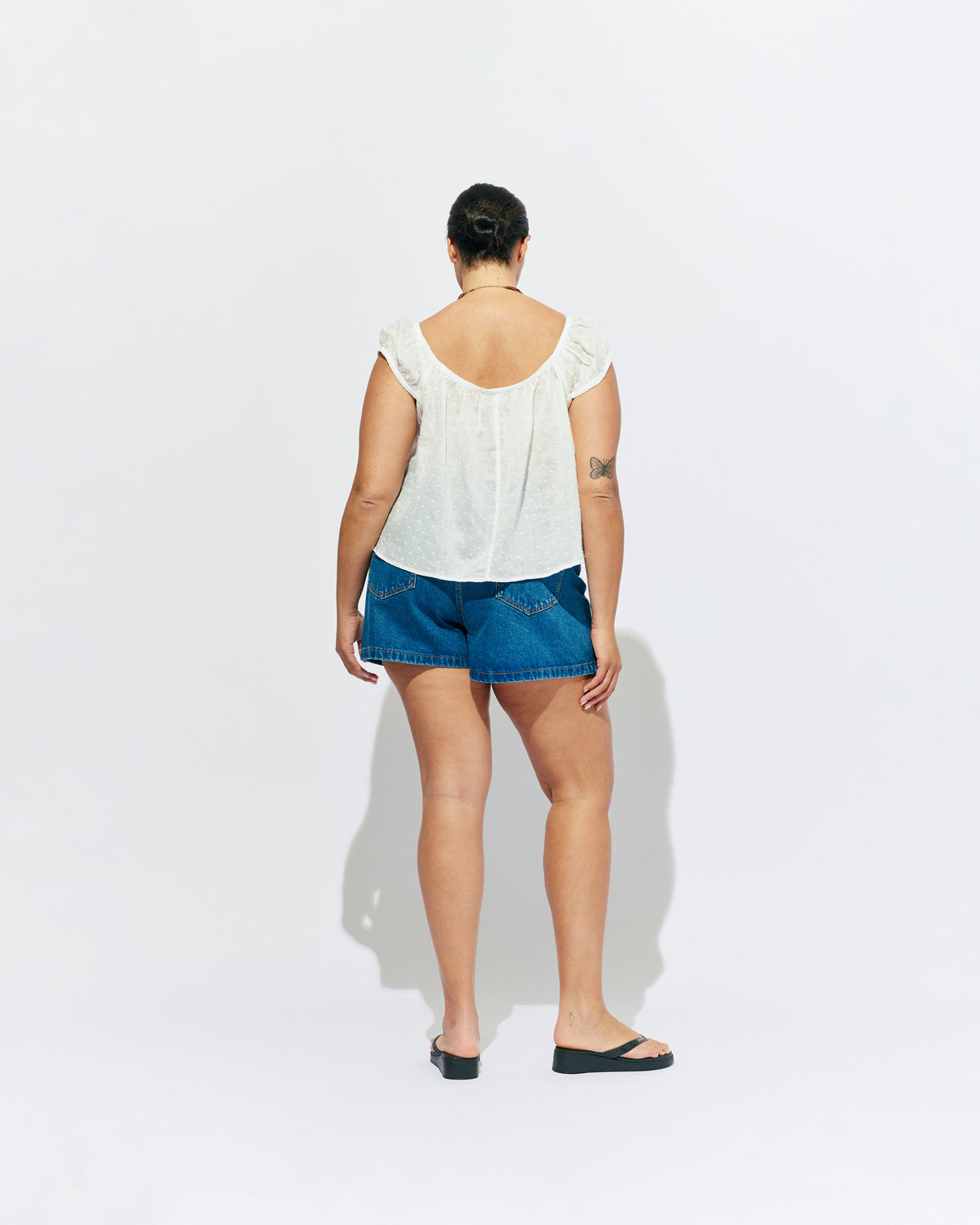 FRECKLE BLOUSE WHITE | Puff sleeve blouse, created in a lightweight semi-sheer ramie fabric, with a textured polka dot design. With a wide neckline that can be worn on or off the shoulder, and a flowy silhouette through the body, this top is the...