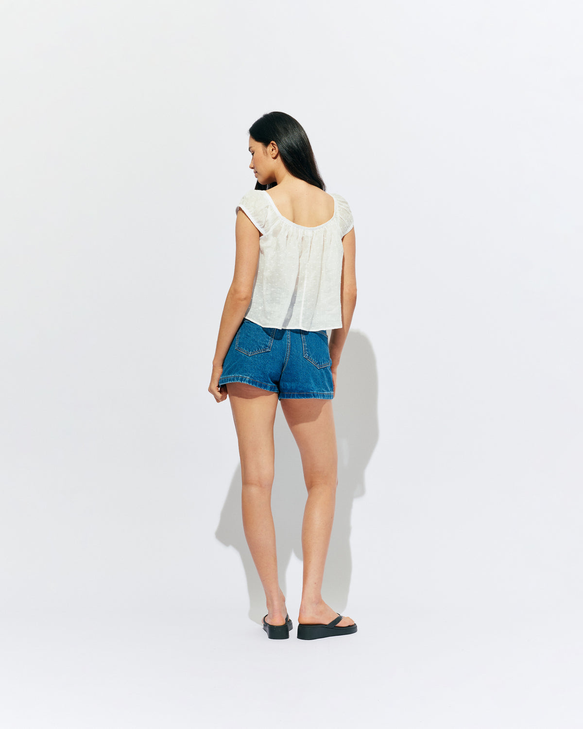 FRECKLE BLOUSE WHITE | Puff sleeve blouse, created in a lightweight semi-sheer ramie fabric, with a textured polka dot design. With a wide neckline that can be worn on or off the shoulder, and a flowy silhouette through the body, this top is the...