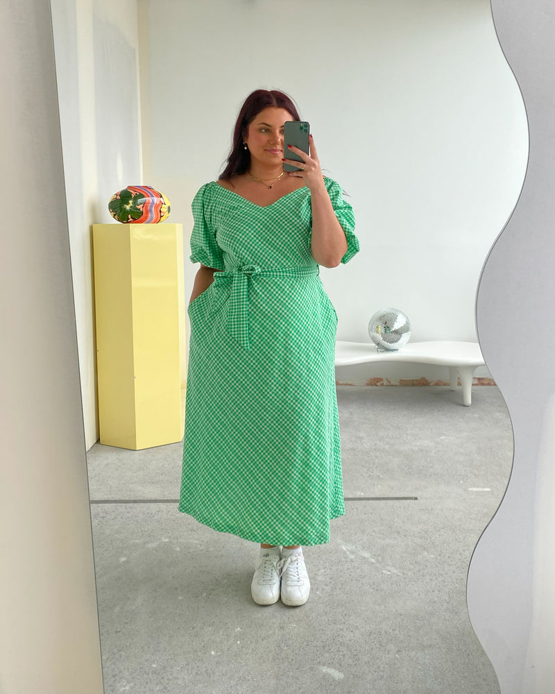 RSR SAMPLE 3500 GEN GINGHAM MIDI DRESS | RUBY Sample Gen Gingham Midi Dress in green. Size 16. One available. Isla is 170cm tall and usually wears a size 16. She measures: BUST: 113cm, WAIST: 100cm, HIP: 129cm