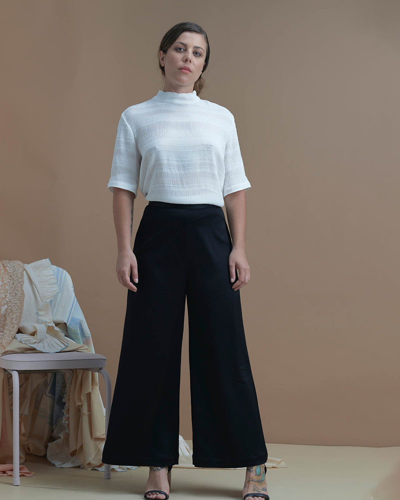 HERA PANT BLACK | The Hera Pant is a classic high-waisted wide-leg pant. It features a fitted waistband with invisible zip closure at centre back. Made from a medium-weight satin with drape, it is...