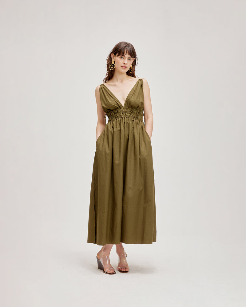 HERO MAXI DRESS OLIVE | Double strap maxi dress with a plungle neckline, shirred waist detail and side split in an olive cotton. The shirring at the waist accentuates the full skirt.