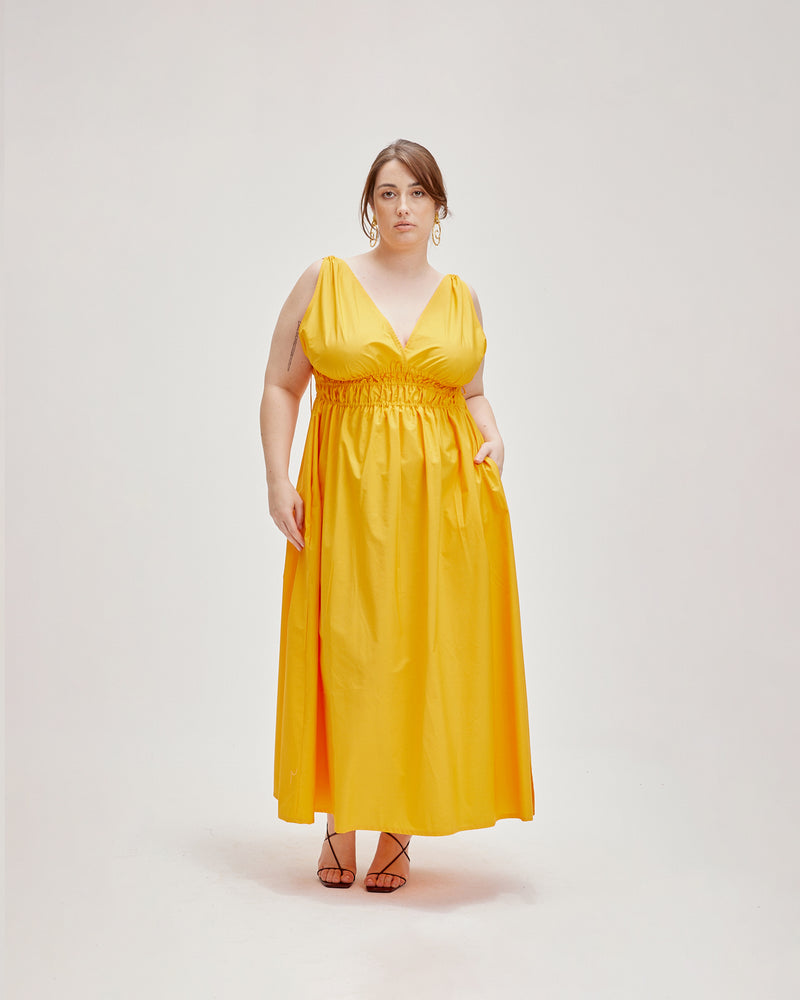 HERO MAXI DRESS MARIGOLD | Double strap cotton maxi dress with a plunge neckline, shirred waist detail and side split in a striking marigold colour. The shirring at the waist accentuates the full skirt.