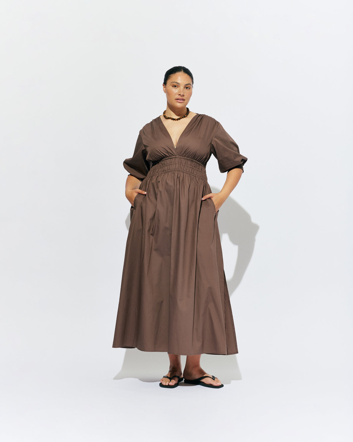 HERO PUFF SLEEVE MAXI DRESS BROWN | An update to our Hero Maxi Dress, this puff sleeve maxi dress features a plunge neckline, shirred waist detail, and side split in a brown organic cotton. A Rubette favourite for any occasion, from weddings to workwear and more.
