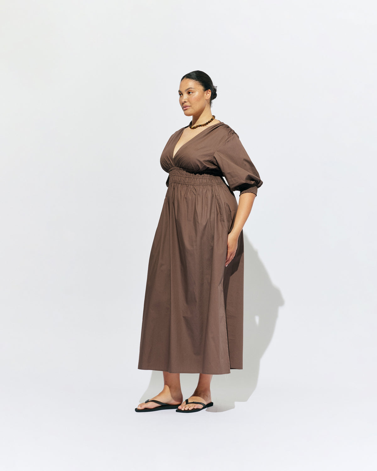 HERO PUFF SLEEVE MAXI DRESS BROWN | An update to our Hero Maxi Dress, this puff sleeve maxi dress features a plunge neckline, shirred waist detail, and side split in a brown organic cotton. A Rubette favourite for any occasion, from weddings to workwear and more.