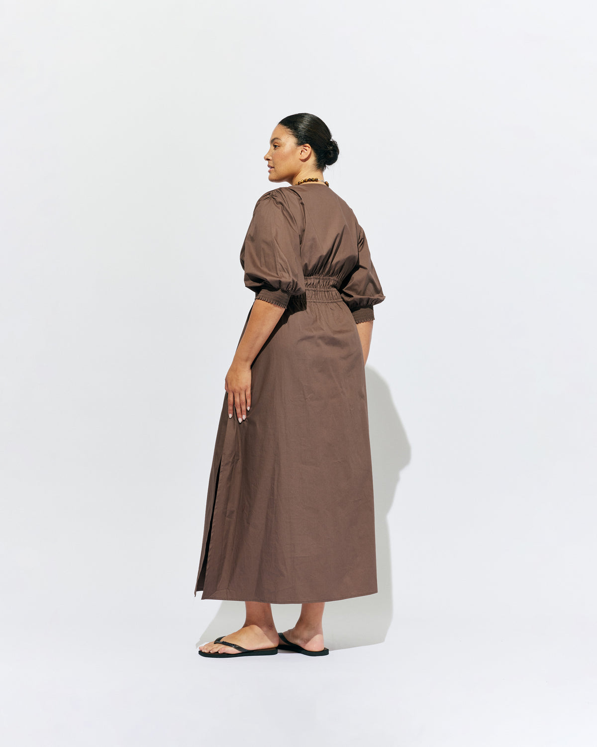 HERO PUFF SLEEVE MAXI DRESS BROWN | An update to our Hero Maxi Dress, this puff sleeve maxi dress features a plunge neckline, shirred waist detail, and side split in a brown organic cotton. A Rubette favourite for any occasion, from weddings to workwear and more.