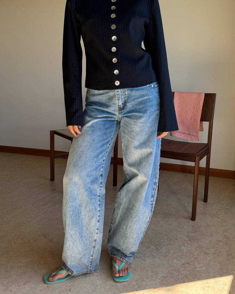 ICON STUDDED JEAN MIDTOWN BLUE | Barrel-leg jean designed in our signature midtown blue wash denim with studded seams. Sits mid to high-waisted with classic 5 pocket and waistband detailing. An updated version of our Icon Jean.