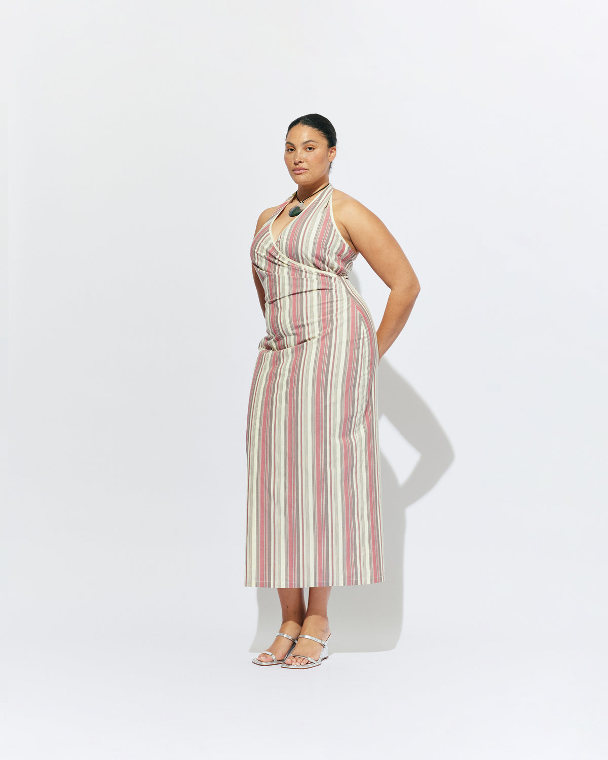 JOEY DRESS ANASE STRIPE | Bias cut midi dress with a tie-up halter neckline, crafted in our anase stripe organic cotton. Designed with ruching details on the waist and back for a tailored fit through the body, which falls into a straight cut skirt with...