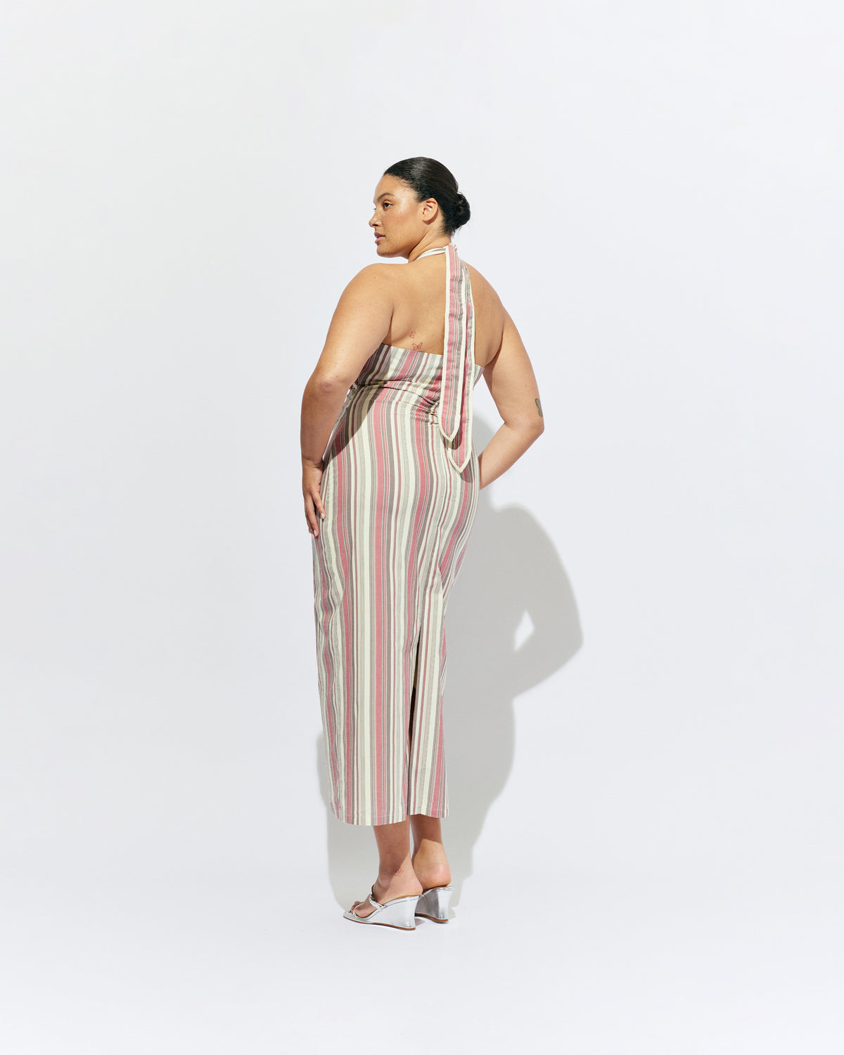 JOEY DRESS ANASE STRIPE | Bias cut midi dress with a tie-up halter neckline, crafted in our anase stripe organic cotton. Designed with ruching details on the waist and back for a tailored fit through the body, which falls into a straight cut skirt with...