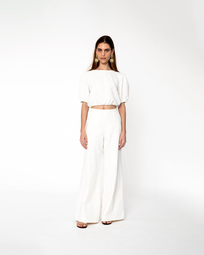 KENDALL TROUSER IVORY | The Kendall Trouser is a high-waisted wide leg trouser. It features pin tucks down the length of the pant leg, two front pockets, and a fitted waistband. It has an...